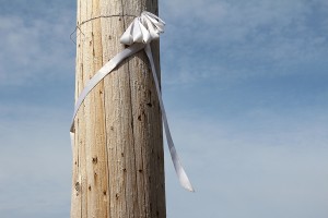 A ribbon hangs across the street from where Jeanetta Riley was killed. Photo by Ben Olson.