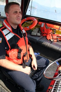 Brandon Hermenet at the helm of the Timberlake Fire Boat. Photo by Ben Olson.