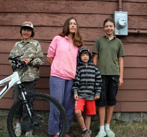 Krista Hess-Mills (center), stands with her family; Josiah (left), Arthur (middle) and Olive (right). Photo by Ben Olson.