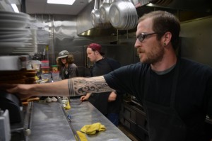 Sous chef Jon Bouer (right); Jarrod Meaux (center); and Austin Johnson (left); busy themselves in the Pend d’Oreille Winery kitchen. Photo by Dion Nizzi.
