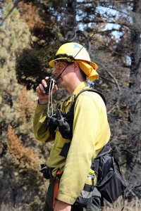 A member of the Missoula crew directs his firefighters up the hill at the Cape Horn fire. Photo by Ben Olson.