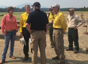 Gov. C.L. "Butch" Otter talking with personnel shortly after landing for an inspection of the Cape Horn fire. Photo by Bill Morse.