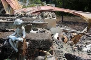 A piece of yard art remains after the home it once decorated is left in ashes. Photo by Ben Olson.