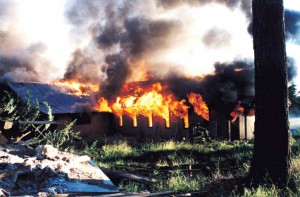 A building at Richard Butler’s Aryan Nations compound in Hayden Lake burns shortly after the group lost a $6.3 million lawsuit to the Southern Poverty Law Center, forcing the forfeiture of the property. Photo courtesy of SPLC.