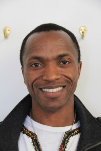 Come Nzibarega from Burundi smiles after telling the Reader about his experience before coming to the U.S. Photo by Ben Olson.