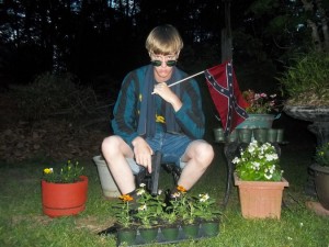 Dylan Roof posing with a Confederate flag and a .45 caliber Glock pistol.