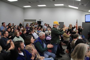 The audience cheers after Mayor Shelby Rognstad withdraws his tolerance resolution. Photo by Ben Olson.