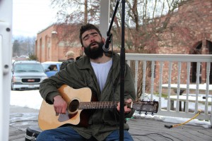The rally ended with a song by a local musician. Photo by Ben Olson.