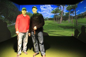 John Bonar (left) and Jeff Boger (right) in front of the golf simulator screen. Photo by Ben Olson.