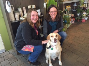 Kim Helms, left, and Petal Talk owner Nicole French, right, pose with Drake.