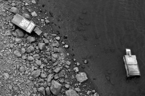 A pair of newspaper boxes tossed into the Coeur d’Alene River. Photo by Ben Olson.