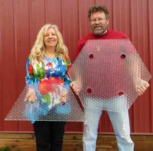 Scott and Julie Brusaw pose with a panel of glass. Courtesy of Solar Roadways.