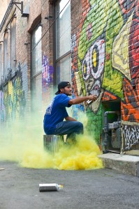 Top: Cody Newton works on a piece in the “Galaxy Gallery” in the alley between First and Second Ave. in Sandpoint. Photo by Lisa Turner.