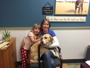 From left to right: Emery Evans and Mandy Evans posing with Drake at the Panhandle Animal Shelter.