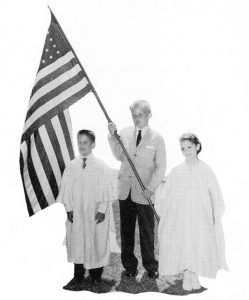 Donald Trump, center, holding the flag during a 1958 graduation at Kew-Forest School in Forest Lawn, NY.