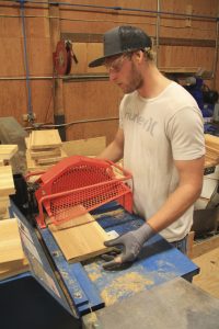 Employee Michael Wallace cuts short lengths of wood in the Chop Room at their Shingle Mill Road facility. Photo by Ben Olson.