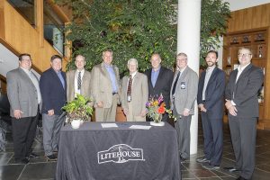 From left to right: Kelly Prior, Brent Carr, Cary Kelly, Jim Frank, Todd Sudick, Dan Hoffman, Glen Bailey, Ben VanGerpen and William Wilson meet Tuesday to sign the tax deferment agreement for the facility expansion. Photo by Cameron Barnes