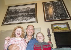 Anya, Charles and Aiden Phillips at their family home in Sagle. Photo by Cameron Barnes