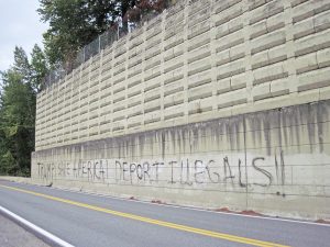 The graffiti in question, sprayed on the retaining wall of the historic Chinese cemetery in Hope. Photo by Sandy Compton.