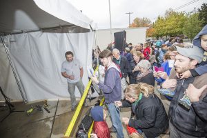 Scott Brusaw, left, unveils the first ever Solar Roadways public demonstration to a crowd of dozens. Photo by Cameron Barnes.