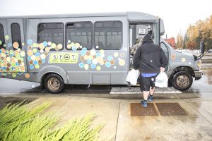 A rider boards the SPOT bus in the blowing rain on Wednesday afternoon in Sandpoint. Photo by Cameron Barnes.