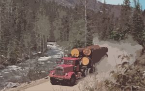 In this vintage photo by Bill Hawkins, a logging truck drives down a mountain road in North Idaho.