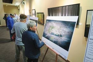Kathy Andruzak looks at one of the display images at the first open house meeting last month. Photo by Ben Olson.