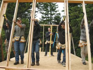 The Eureka Center program participants erect one of the shelters that will be placed at bus stops. Courtesy photo.