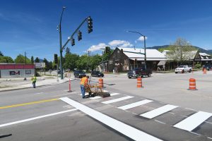City workers paint new crosswalk stripes and traffic lanes at the intersection between Fifth Ave. and Cedar St. on Monday. Traffic will revert to two-way on Fifth Ave. on Thursday morning. Photo by Ben Olson.