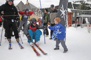 Matt Gillis, center, pounds a fist with Hank Sturgis during 24 Hours for Schweitzer 2017. Courtesy photo.