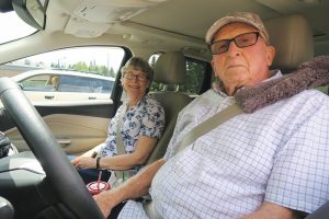 Robert Ashbrooke behind the wheel with his wife Velta. Photo by Ben Olson.