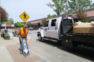 A road crew member takes down the one-way signs in downtown Sandpoint. Photo by Ben Olson.